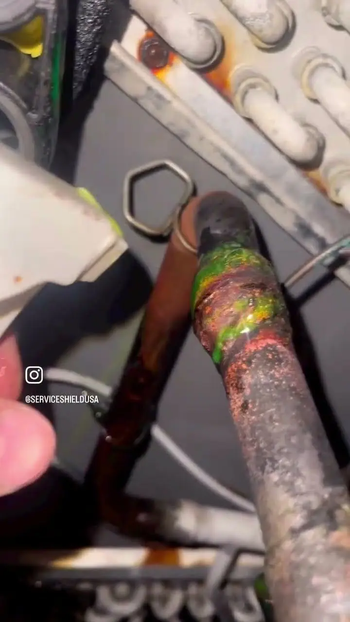 Video thumbnail showing a heavily corroded copper refrigerant line and joint below the bends of an AC coil