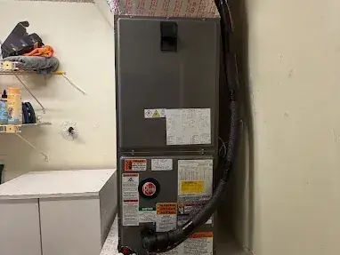 New air handler installed in a utility room, with an insulated plenum above it