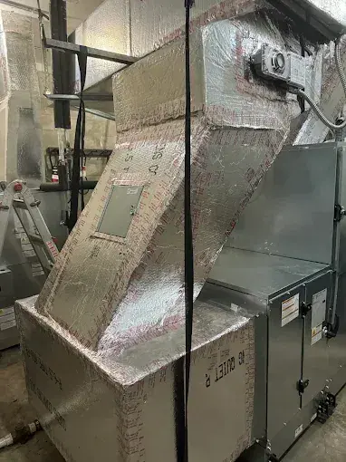 New air handler with an insulated supply plenum and ductwork above it