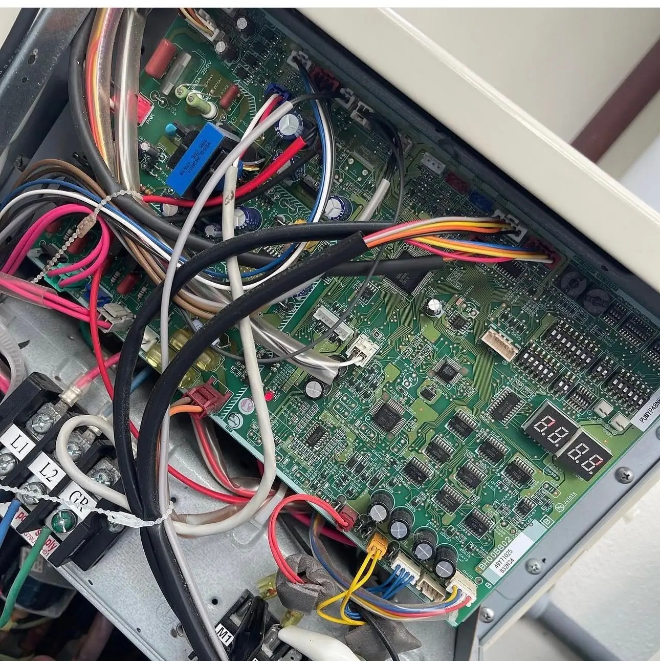 Control board with a two-digit diagnostic display inside a variable-speed outdoor unit