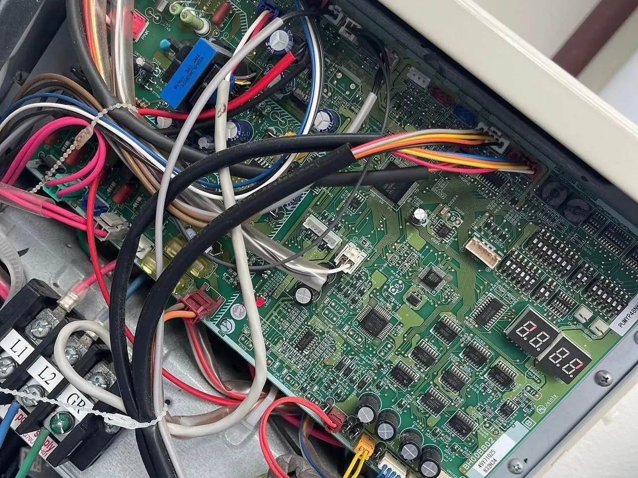 Control board with a two-digit diagnostic display inside a variable-speed outdoor unit