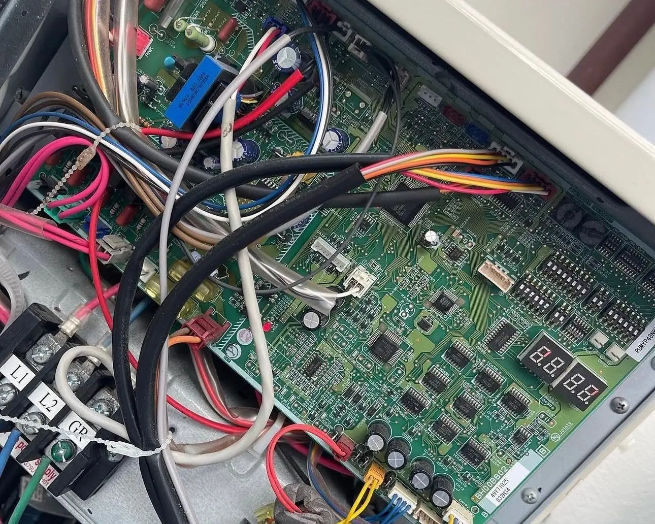 Control board with a two-digit diagnostic display inside a variable-speed outdoor unit
