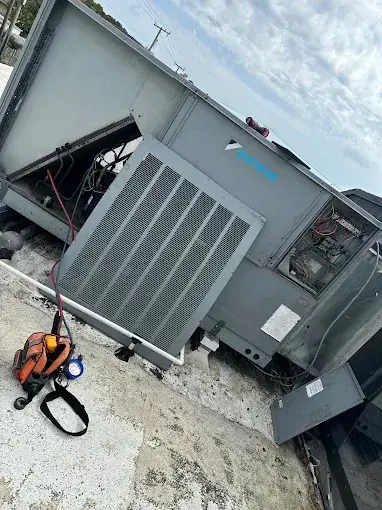 Rooftop packaged unit with its panels open on a service call