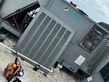 Rooftop packaged unit with its panels open on a service call